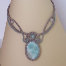 Necklace in taupe gray/frosted blue micro-macramé with a natural gemstone in soft shades of white and light blue in the center.
